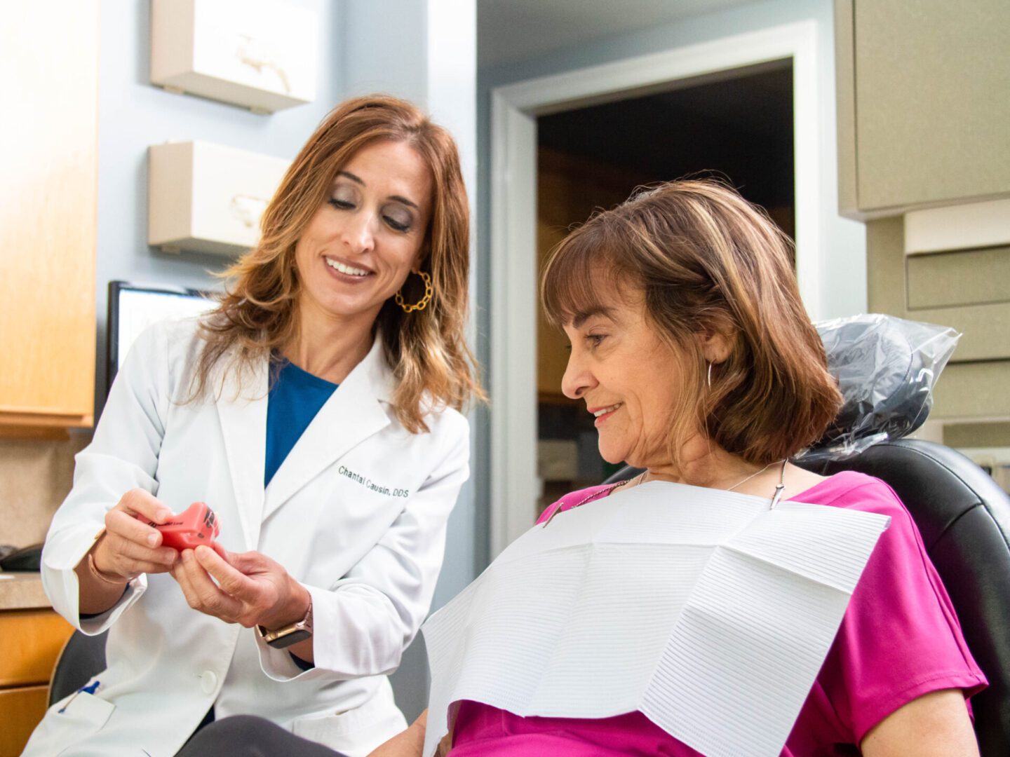 Dentist explaining dental care to a patient in a clinic.